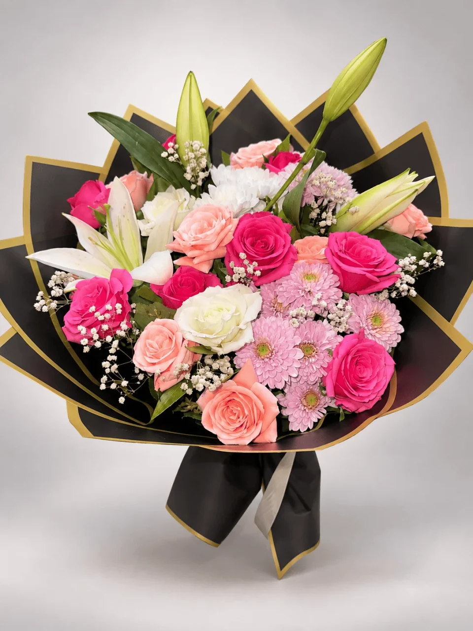 Rosa Unica rose and lily bouquet in black and gold wrapping for flower delivery in Casablanca